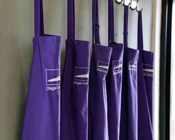 five purple Dingle Cookery School aprons hanging in a row dingle Peninsula Kerry Ireland