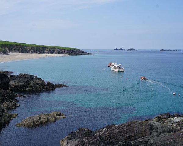  ferry anchored at blasket island with RIB carrying passengers to boat