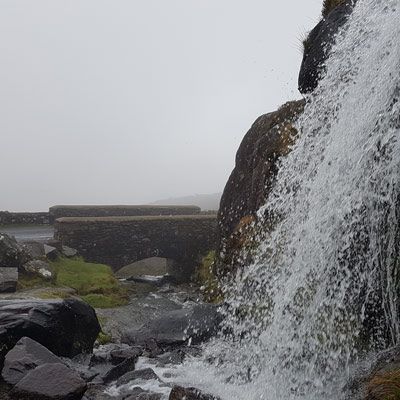 waterfall bridge and mist on the Conor Pass Dingle Peninsula 