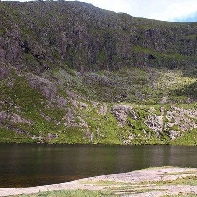 corrie lake with cliff rising up behind at Lough Doon Dingle Peninsula 